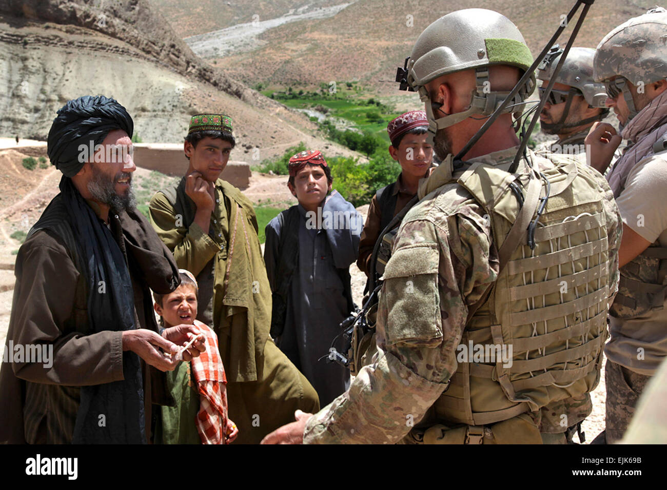 U.S. Army Special Forces Soldiers speak with a village elder during a Convoy Reconnaissance Patrol at Badamak, in the Uruzgan province of Afghanistan, May 23, 2011.  The purpose of the patrol is to build relationships and trust with local citizens and assess safety, security, and insurgent threats in the area.  Pfc. Simon Lee Stock Photo