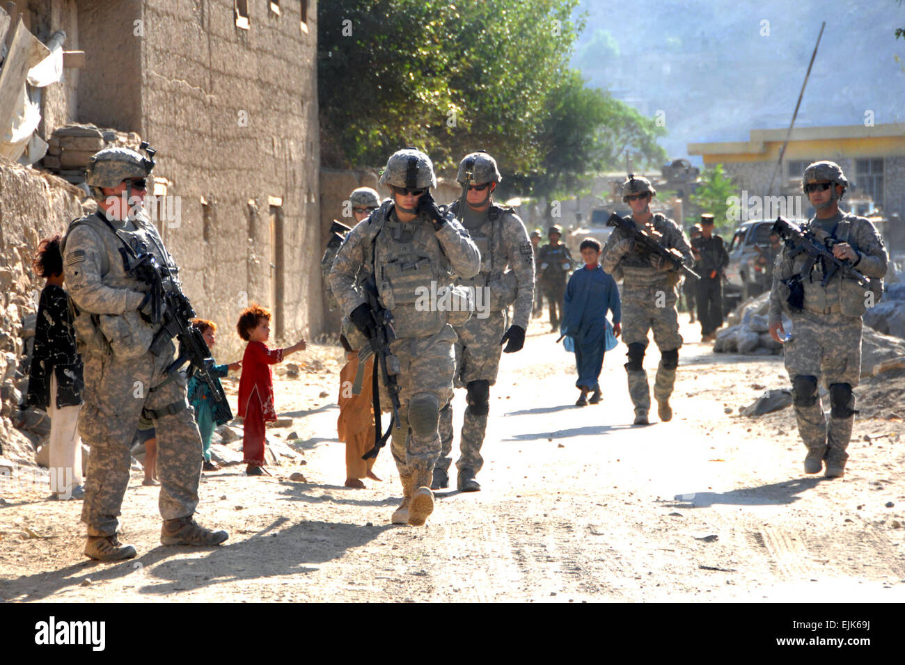 U.S. Army Soldiers conduct a dismounted patrol in a village near
