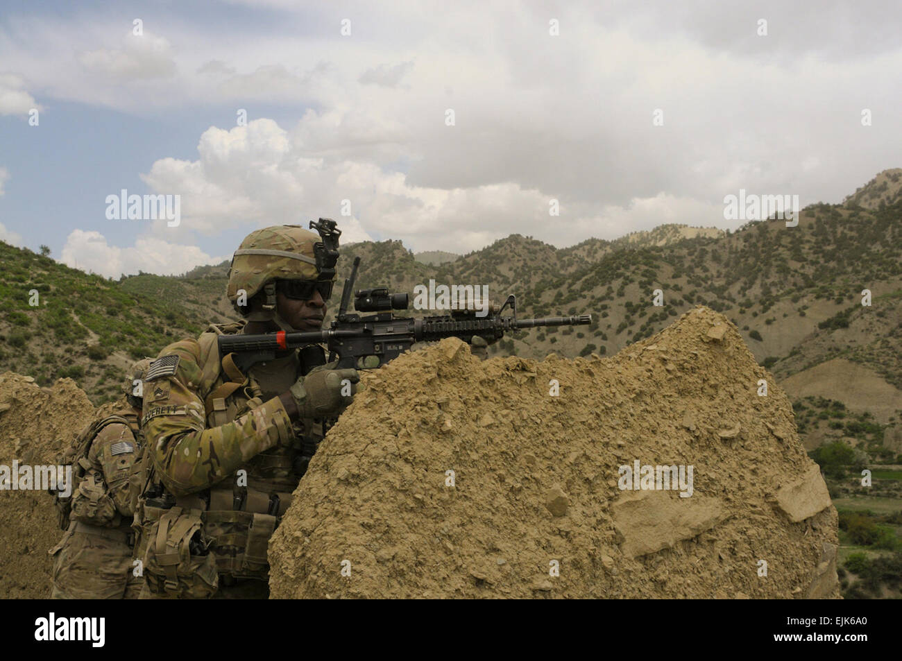 U.S. Army Sgt. Brandon Everett, a native of Thomasville, Ga., fire support sergeant assigned to Troop C, 1st Squadron, 40th Cavalry Regiment, pulls security during a dismounted patrol in Musa Kheyl village, June 5. Soldiers from 3rd Platoon, stationed at Combat Outpost Deysie, patrolled the village with members of the Afghan National Army, to talk with locals and search for weapon caches. Stock Photo