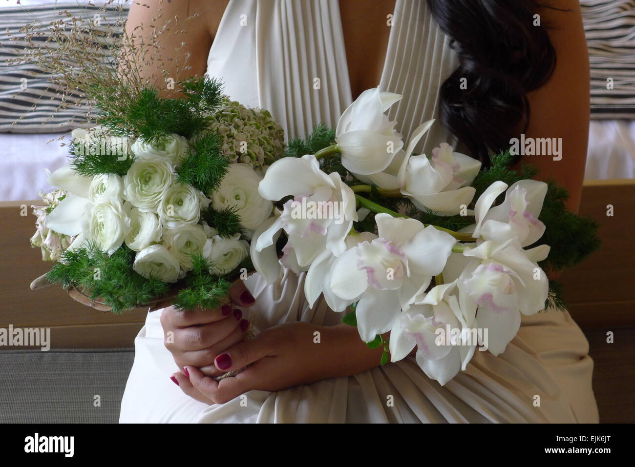 woman holding wedding bouquet with white orchids Stock Photo