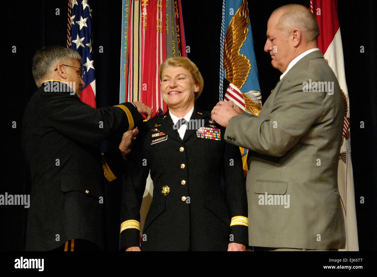 U.S. Army Lt. Gen. Ann E. Dunwoody smiles during her promotion to General, where she was pinned by Chief of Staff of the Army General George W. Casey, left, and her husband Craig Brotchie during her ceremony at the Pentagon Nov. 14, 2008.  Dunwoody made history as the nations first 4 star female officer.   U.S. Navy Petty Officer 2nd Class Molly A. Burgess Stock Photo