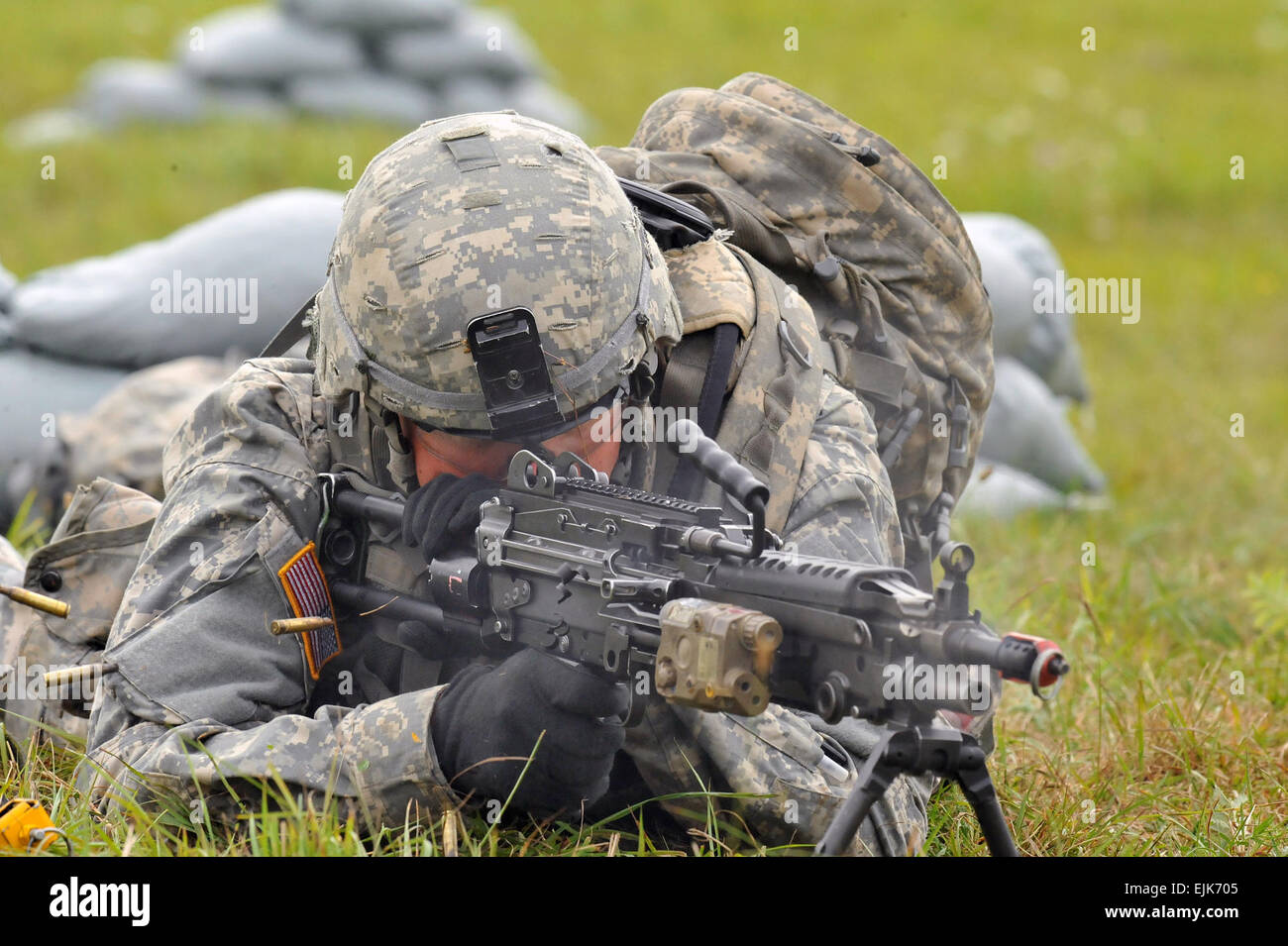U.S. Army Spc.  Stabler, assigned to Joint Multinational Training Command, fires the M249 squad automated weapon during the Expert Infantryman Badge testing Aug. 27, 2012 at Grafenwoehr, Germany Training Area. Stock Photo