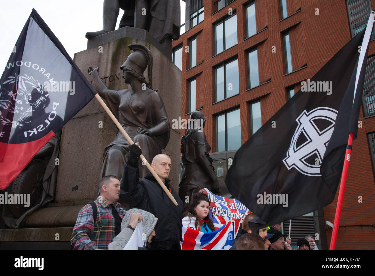 Far right demonstrators with flags & banners at the National Front and White Pride Demo in Piccadilly, Manchester, 28th March, 2015.  Arrests were made as Far Right 'White Pride' Polish Natiuonal Movement group gathered in Manchester to stage a demonstration when about 50 members of the group waved flags and marched through Piccadilly Gardens. Anti-fascist campaigners staged a counter-demonstration and police line separated the two sides. Greater Manchester Police said two arrests were made, one for a breach of the peace. The second was also held for a public order offence. Stock Photo