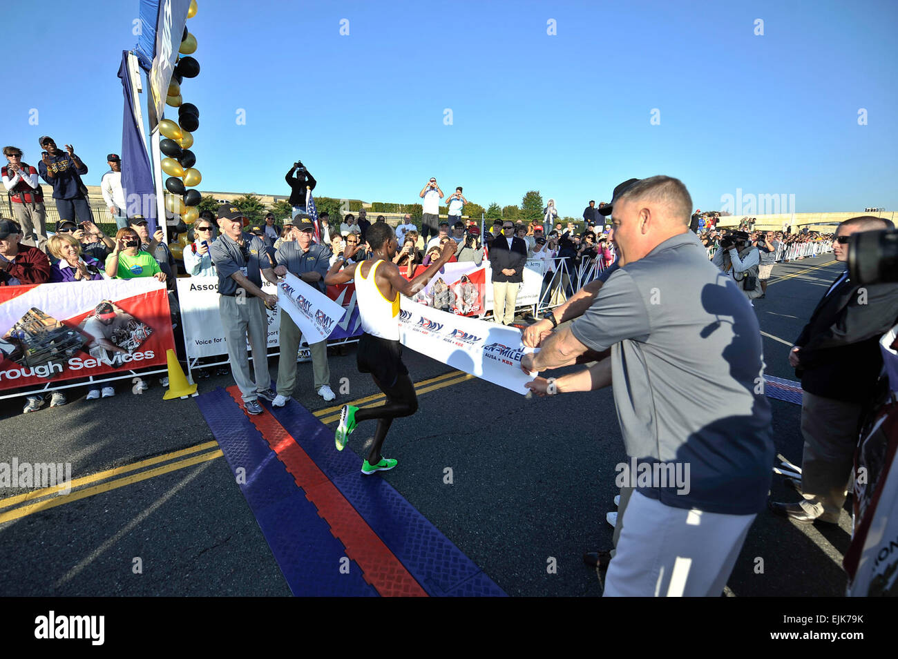 Retired Army Gen. Gordon R. Sullivan, President &amp; Chief Operating Officer of the Association of the United States Army, Gen. Raymond T. Odierno, Chief of Staff of the Army, Hon. John McHugh, Secretary of the Army, and Sergeant Major of the Army Raymond F. Chandler III  hold a banner at the finish line for the winner of the 2011 Army Ten Miler in Washington, D.C. Oct. 9, 2011.  Staff Sgt. Teddy Wade Stock Photo