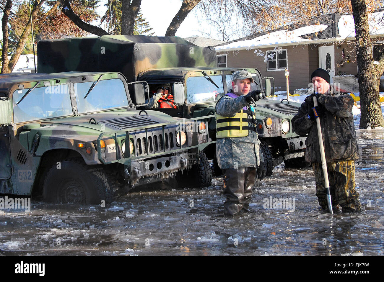 U.S. Army Staff Sgt. Robin Mattson speaks with a local resident while patrolling in Moorhead, Minn., March 28, 2009. Approximately 500 members of the Minnesota National Guard, under the direction of the Governor of Minnesota, continue to provide assistance to civil authorities in support of flood-fighting efforts.  Master Sgt. Jason W. Rolfe Stock Photo