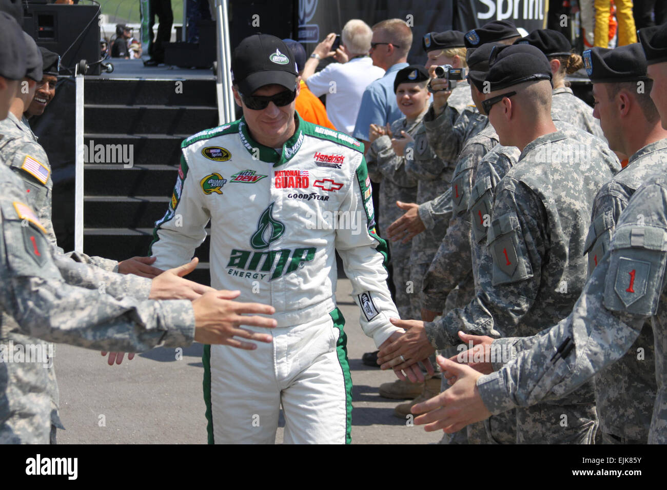 Soldiers from the 4th Infantry Brigade Combat Team, 1st Infantry Division greet Dale Earnhardt, Jr., driver of the number 88 AMP Energy Drink/National Guard car in the NASCAR Sprint Cup Series, as they participate in driver introductions at Kansas Speedway, June 5.  Nearly 300 Soldiers from the “Big Red One” participated in the pre-race ceremonies including the driver introduction cordon, the color guard and unfurling two giant American Flags during the National Anthem.   U.S. Army  Sgt. 1st Class Jake A. Newman, 1st Infantry Division Stock Photo