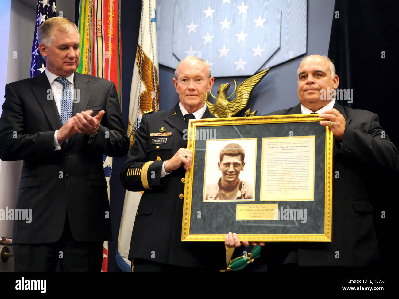 Deputy Defense Secretary William J. Lynn III applauds as Chief of Staff of the Army Gen. Martin Dempsey presents the Hall of Heroes induction plaque to George Kaho'ohanohano, nephew of Korean War Medal of Honor recipient Army Private 1st Class Anthony Kaho'ohanohano, during a ceremony at the Pentagon, May 3, 2011.  Defense Department photo by Cherie Cullen  /medalofhonor/?ref=home-spot0-title  /medalofhonor/?ref=home-spot0-title Stock Photo