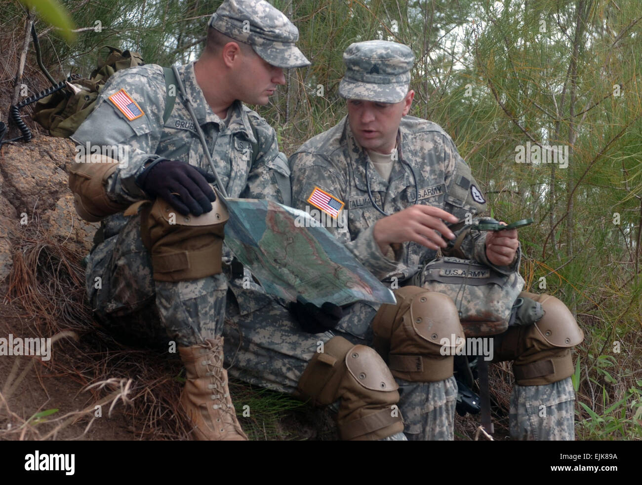 Pvt. Juston Grubbs and Sgt. Thomas Tallman both with 2nd Squadron 6th Cavalry Regiment, 25th Combat Aviation Brigade look over maps and compasses for a call to fire exercise during the 2-6 CAV FTX held at Dillingham Airfield, Hawaii.  Sgt. Bryanna Poulin Stock Photo