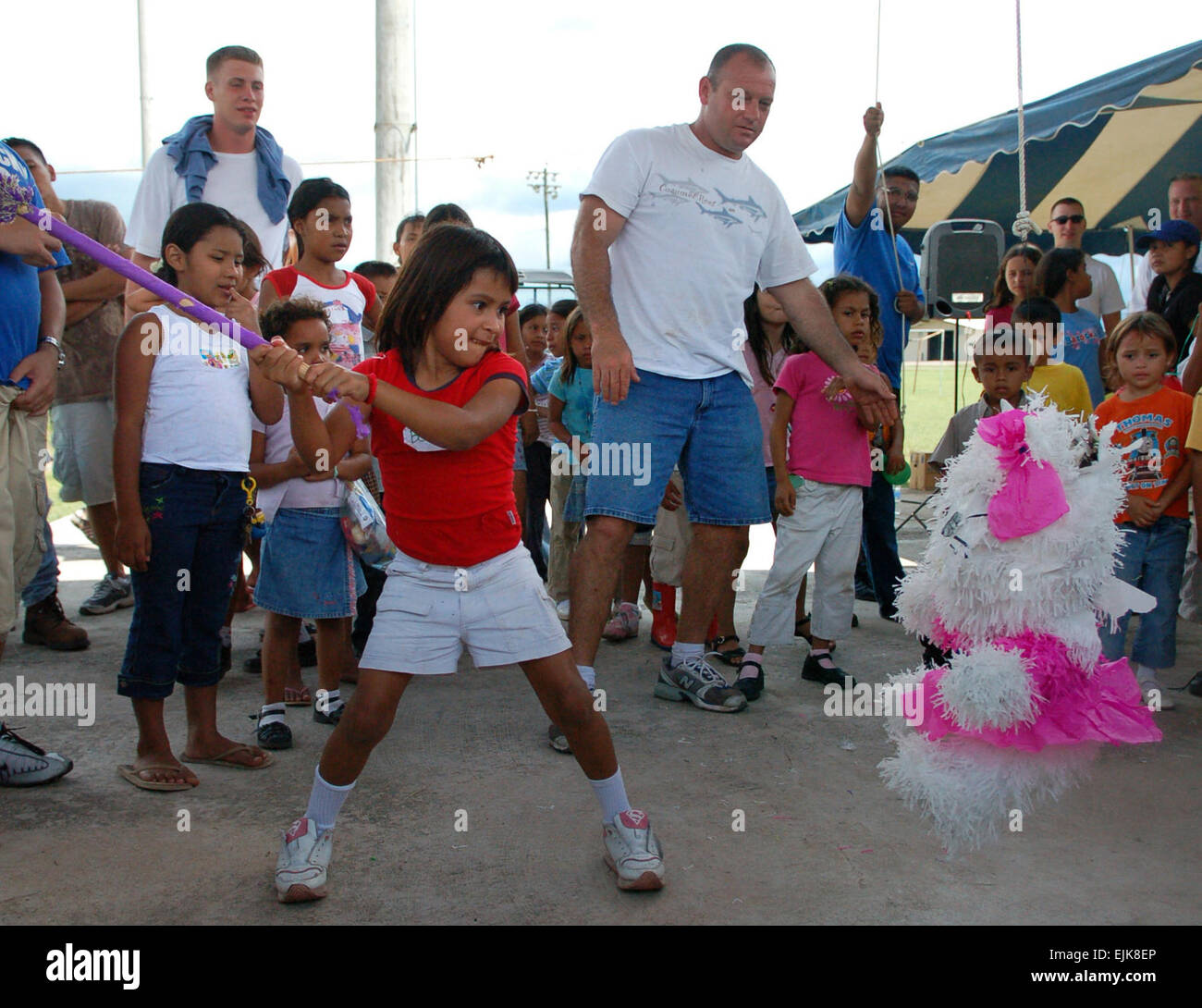 A young Honduran girl winds up to deliver a crushing blow to a pinata while her friends cheer her on at Soto Cano Air Base, Honduras, Sept. 22, 2007. Approximately 90 children from Nuestra Senora de Guadalupe Children's Home in Comayagua came out to enjoy the Annual Kids Day celebration.   Staff Sgt. Austin M. May Stock Photo