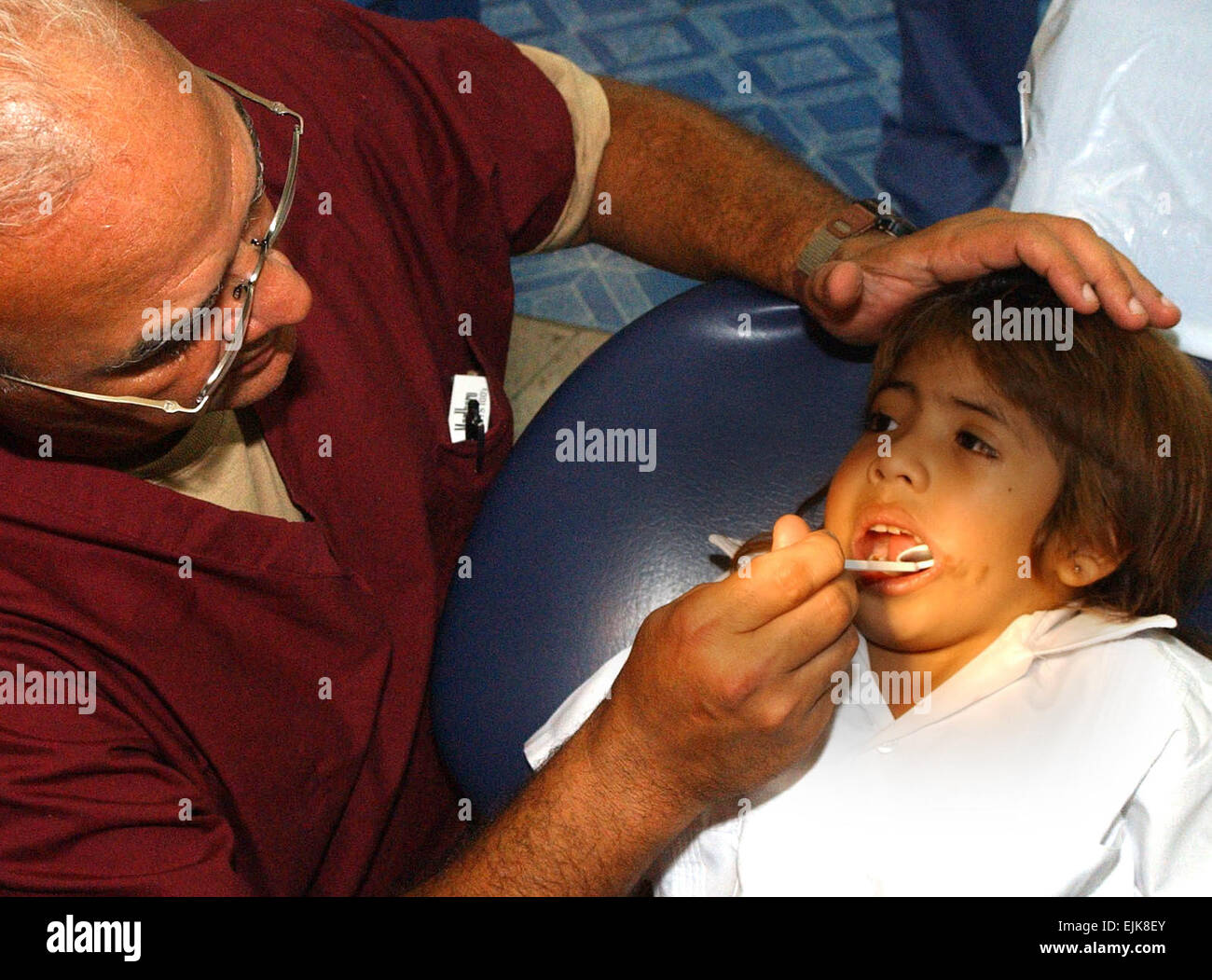 U.S. Army Lt. Col. Manuel Marien, a pediatric dentist from Fort Hood, Texas, examines the teeth of a Honduran child during a medical readiness training exercise in Tegucigalpa, Honduras, Aug. 14, 2007.  U.S. Army Soldiers and U.S. Air Force Airmen are helping hundreds of Honduran children and providing much needed dental care at the Catholic University Dental School.  1st Lt. Erika Yepsen Released Stock Photo
