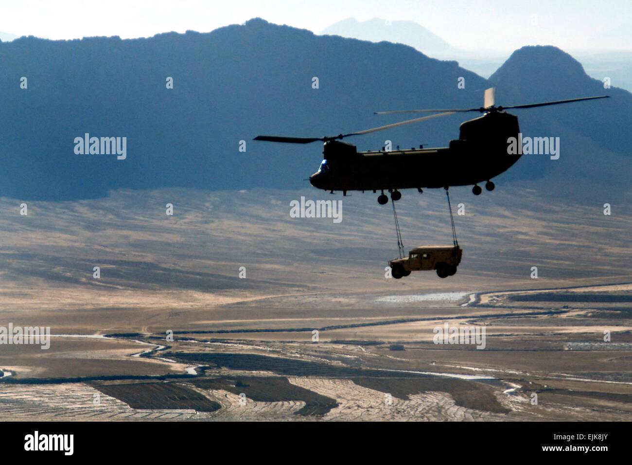 A U.S. Army CH-47F Chinook helicopter sling-loads a Humvee over Kandahar Province, Afghanistan, Dec. 25, 2009.  Staff Sgt. Aubree Rundle Stock Photo