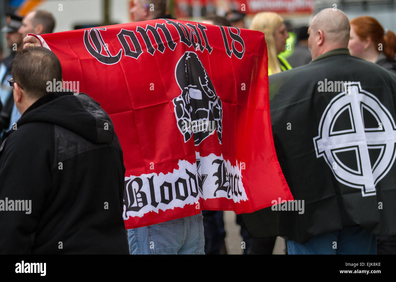 Combat 18 Blood & Honour right-wing extremist political group red banner in Manchester, UK March, 2015. Demonstrators at the National Front and White Pride Demo in Piccadilly.  Arrests were made as Far Right 'White Pride' group gathered in Manchester to stage a demonstration when about 50 members of the group waved flags and marched through Piccadilly Gardens. Anti-fascist campaigners staged a counter-demonstration and police line separated the two sides. Greater Manchester Police said two arrests were made, one for a breach of the peace. Stock Photo
