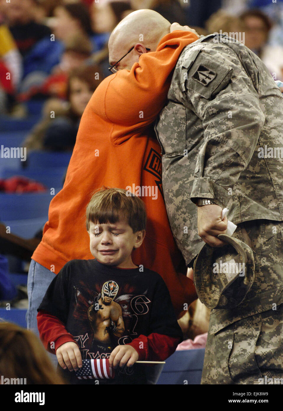 U.S. Army Sgt. Shane Pudgett, of the 76th Infantry Brigade Combat Team, hugs his wife goodbye as his son cries during a going away ceremony Jan. 2, 2008, at the RCA Dome in Indianapolis, Ind. The Indiana National Guard is preparing to deploy its largest amount of Soldiers since World War II with more than 3,400 Soldiers scheduled to depart for Iraq to serve during their 12-month rotation.  Staff Sgt. Russell Klika, Stock Photo