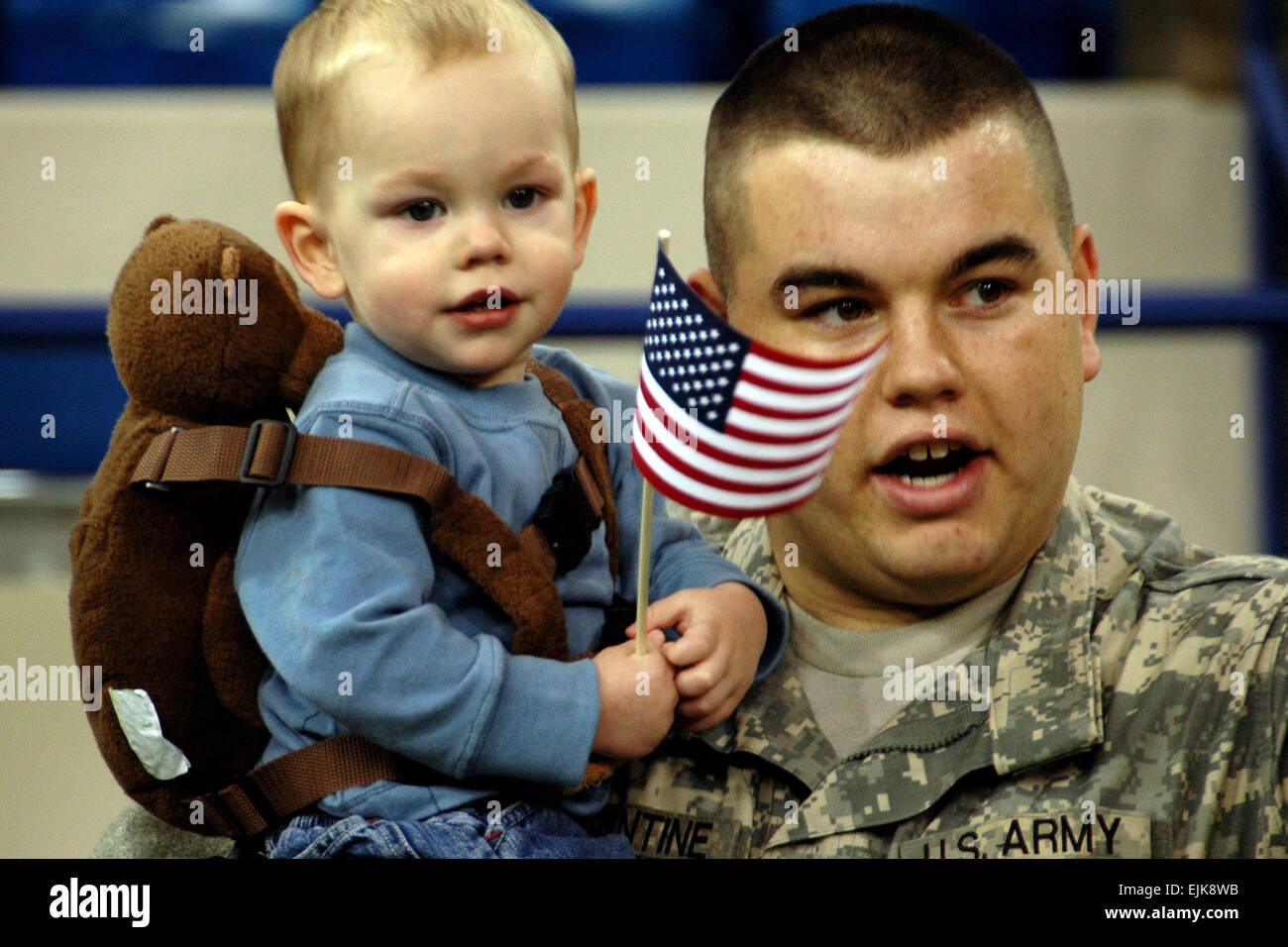 An Army Soldier holds his son during the 76th Brigade Combat Team's departure ceremony at the RCA Dome in Indianapolis, Ind., Jan. 2, 2008. With more than 3,400 Soldiers from approximately 30 Indiana communities deploying for a 12-month tour in Iraq, this is the largest Indiana National Guard deployment since World War II.  Sgt. 1st Class Peter Eustaquio Released Stock Photo