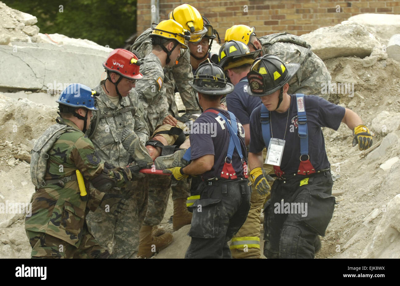 U.S. Army and Air National Guard members assigned to the Ohio National Guard's Chemical, Biological, Radiological, Nuclear Enhanced Response Force Package practice extracting victims trapped in the rubble of a collapsed building during Vigilant Guard at the Muscatatuk Urban Training Center near North Vernon, Ind., May 11, 2007. Vigilant Guard exercise is a joint military and civilian emergency management hosted by the Indiana National Guard that simulates the detonation of a nuclear device in a major metropolitan area.  Staff Sgt. Russell Lee Klika Stock Photo