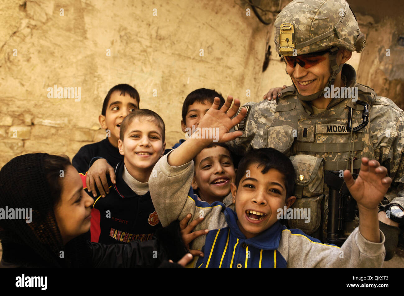 U.S. Army 1st Lt. Michael Moore is surrounded by Iraqi children during a patrol the Rusafa neighborhood of Baghdad, Iraq, on Feb. 17, 2008.  Moore is a platoon leader with 3rd Platoon, Charlie Company, 1st Battalion, 504th Parachute Infantry Regiment.  Staff Sgt. Jason T. Bailey, U.S. Air Force.  Released Stock Photo
