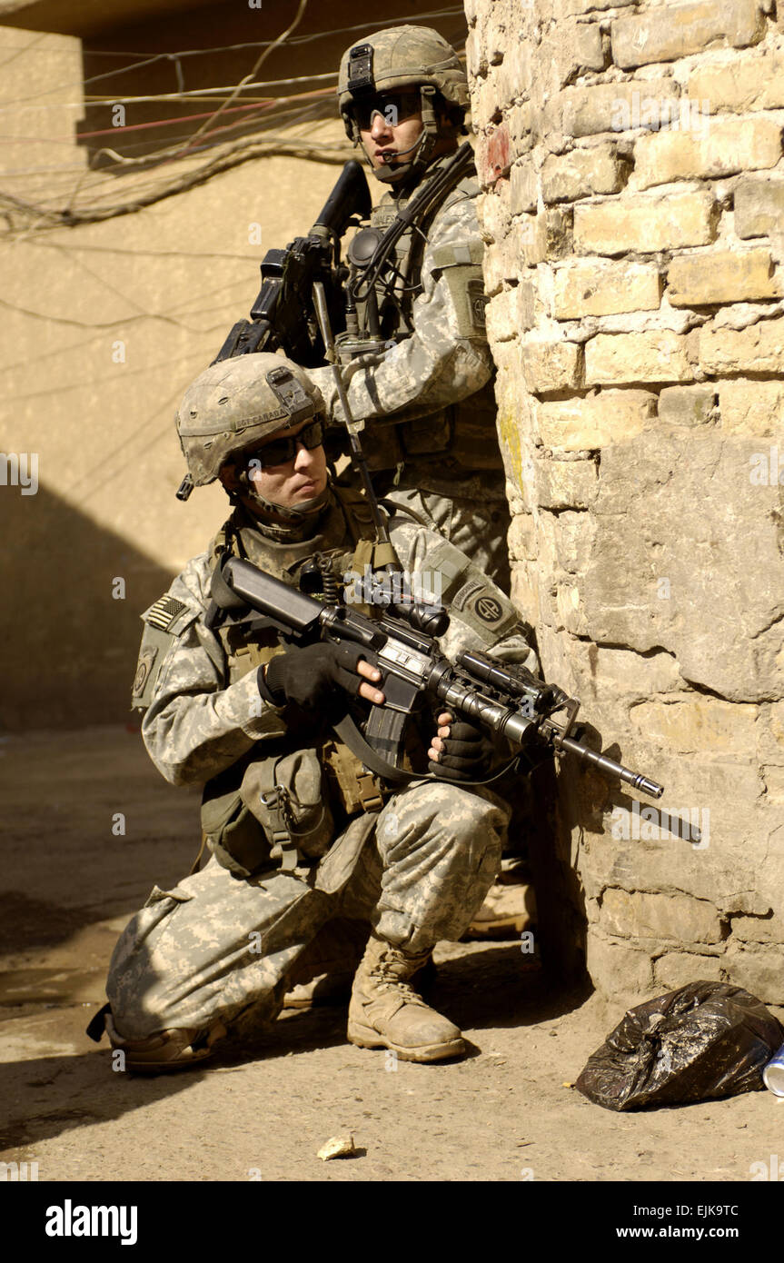 U.S. Army Spc. Canales and Sgt. Canada, 3rd Platoon, Charlie Company, 1st Battalion, 504th Parachute Infantry Regiment, provide security during a patrol of Rusafa, Baghdad, Iraq, Feb. 17, 2008.  Staff Sgt. Jason T. Bailey Released Stock Photo