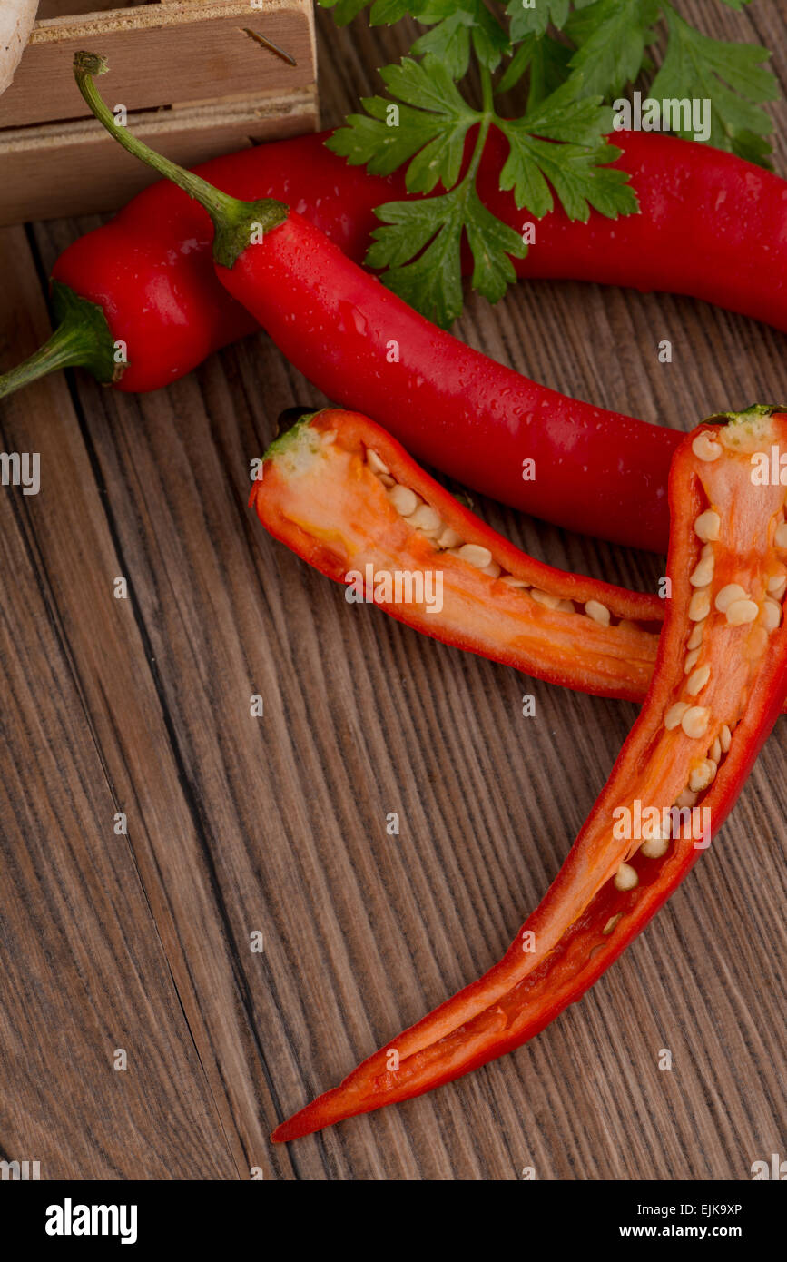 Colored bell peppers on old wooden table Stock Photo - Alamy