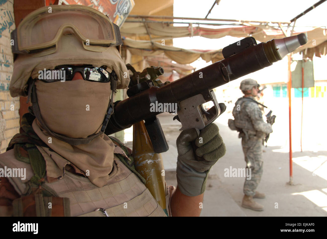 An Iraqi army soldier poses for a picture with his weapon during a mission in Mahmudiyah, Iraq, March 30, 2008.  Spc. Richard Del Vecchio Released Stock Photo