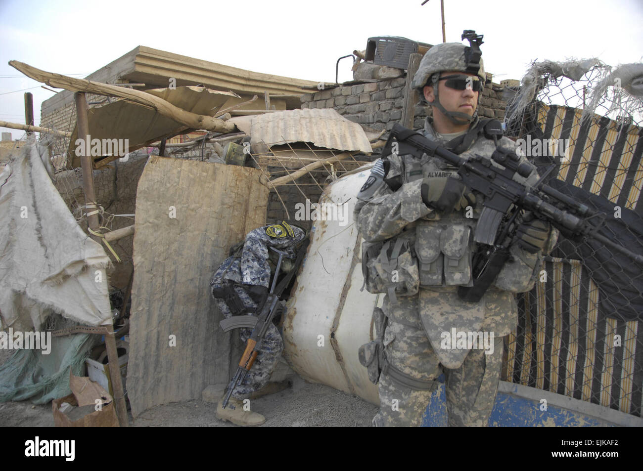 A member of the U.S. Army National Police Transition Team searches for weapons caches during a an operation with Iraqi National Police in Jisr Diyala, Iraq, March 31, 2008.  Sgt. Eric C. Hein Released Stock Photo