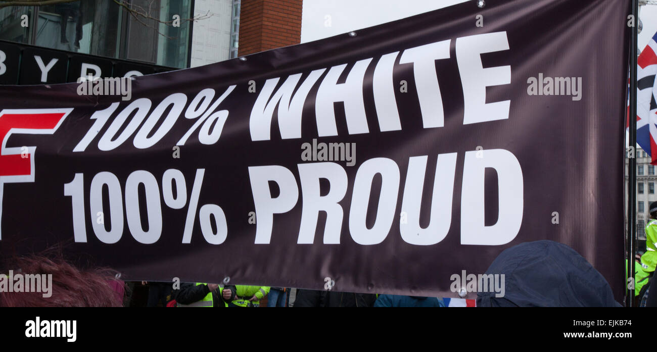 Manchester, UK March, 2015. Combined National Front neo-nazi rally & 100% White Pride Demo in Piccadilly.  Arrest made as Far Right 'White Pride' group gathered in Manchester to stage a demonstration. Around 50 members of the group waved flags and marched through Piccadilly Gardens. With anti-fascist campaigners staging a counter-demonstration police line separating the two sides. Greater Manchester Police said two arrests were made, one for a breach of the peace. The second was also held over a public order offence. Stock Photo