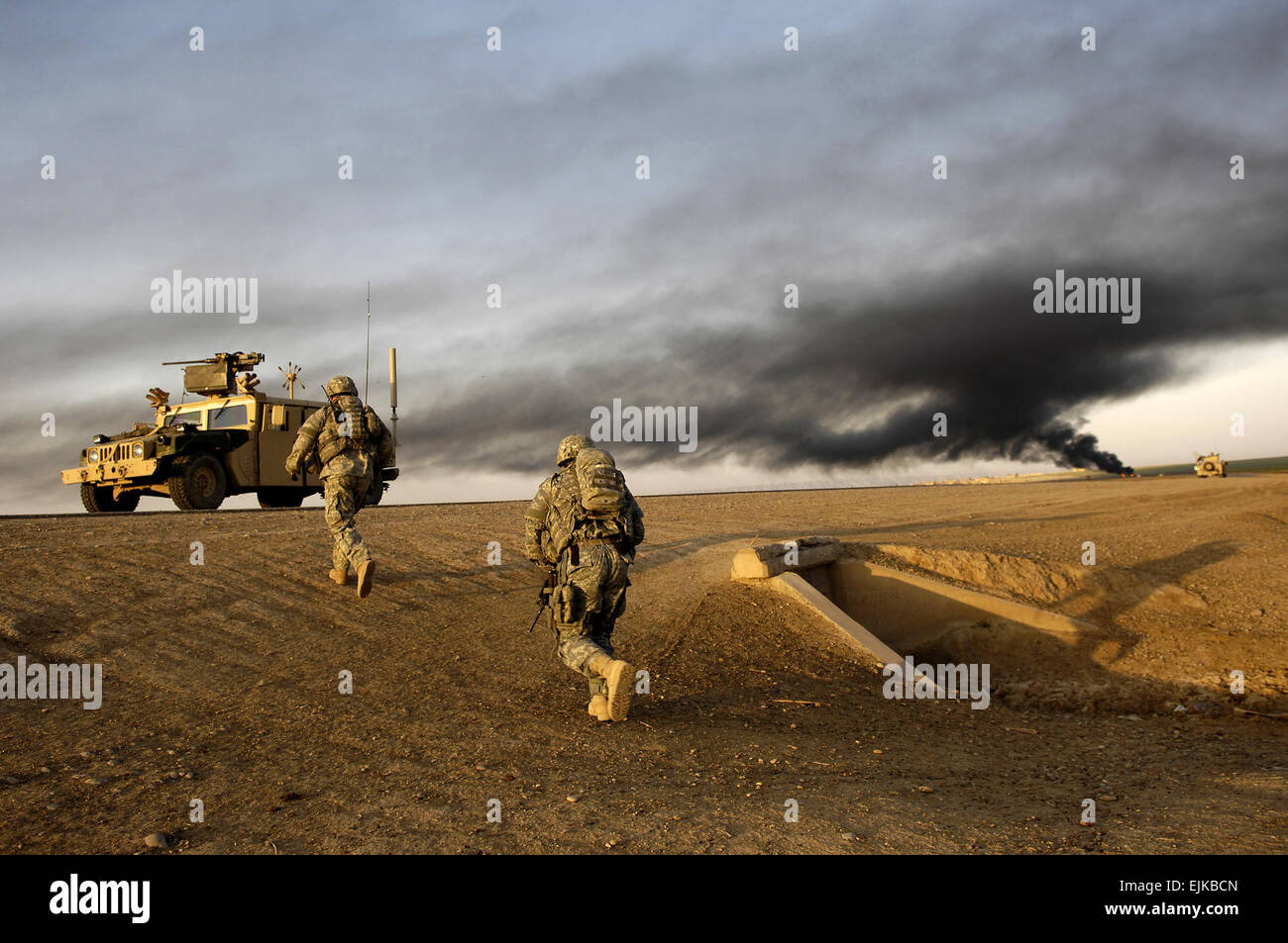 U.S. Army Sgt. Sean Bundy and Sgt. Dennis First walk to the rally point to link up with the Iraqi army soldiers from 1st Battalion, 2nd Brigade, 4th Iraqi Army Division for an Iraqi army-led operation in Al Muradia village, Iraq, March 12, 2007. Bundy and First are assigned to 4th Platoon, Delta Company, 2nd Battalion, 27th Infantry Regiment, 3rd Brigade Combat Team, 25th Infantry Division, Schofield Barracks, Hawaii.  Master Sgt. Andy Dunaway Stock Photo