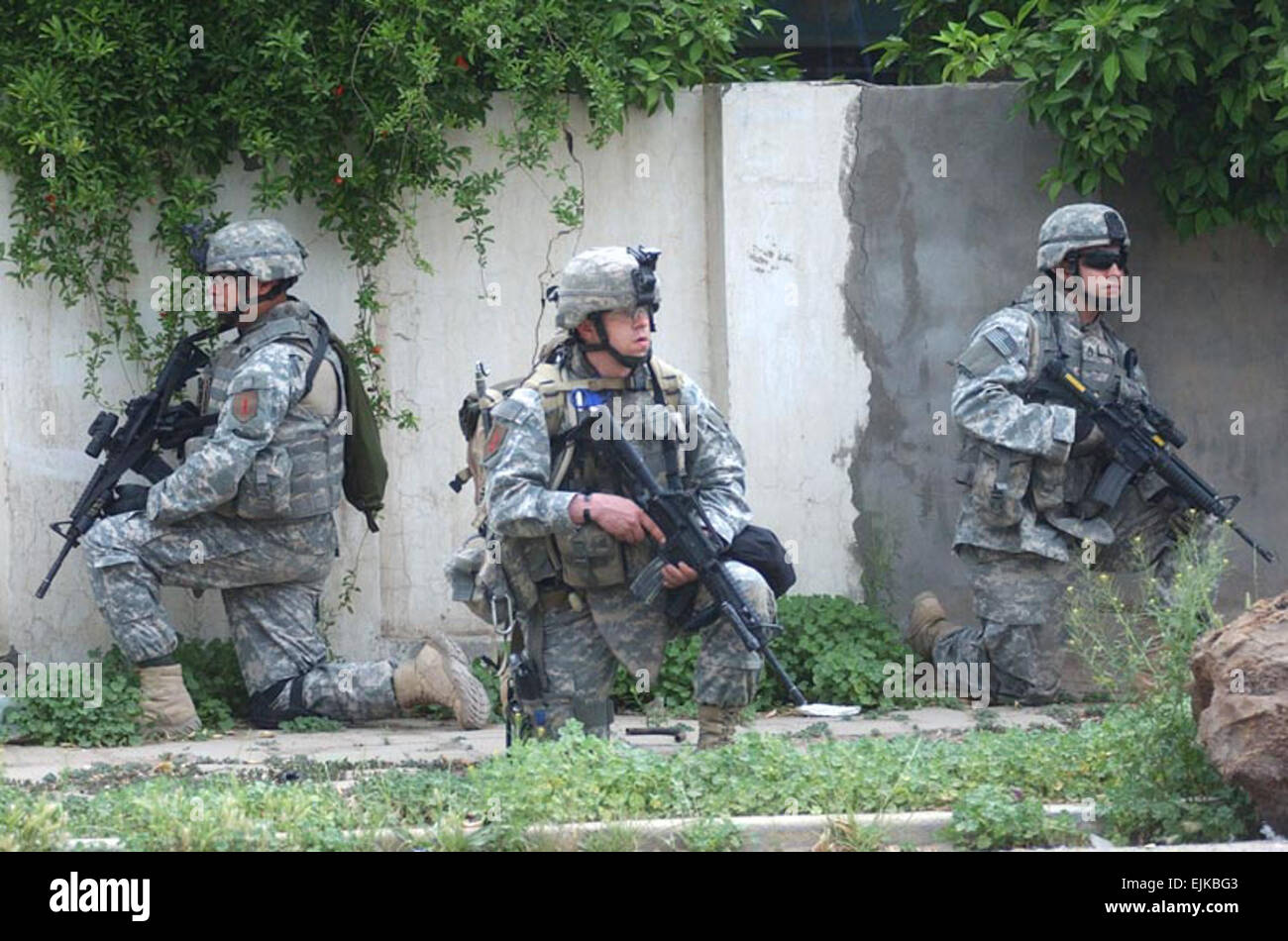 Sgt. First Class Tim Ybay from Long Beach, Calif., with C Company, 1st  Battalion, 26th Infantry Regiment, kneels and reflects after returning to  forward operating base Apache in eastern Baghdad after an