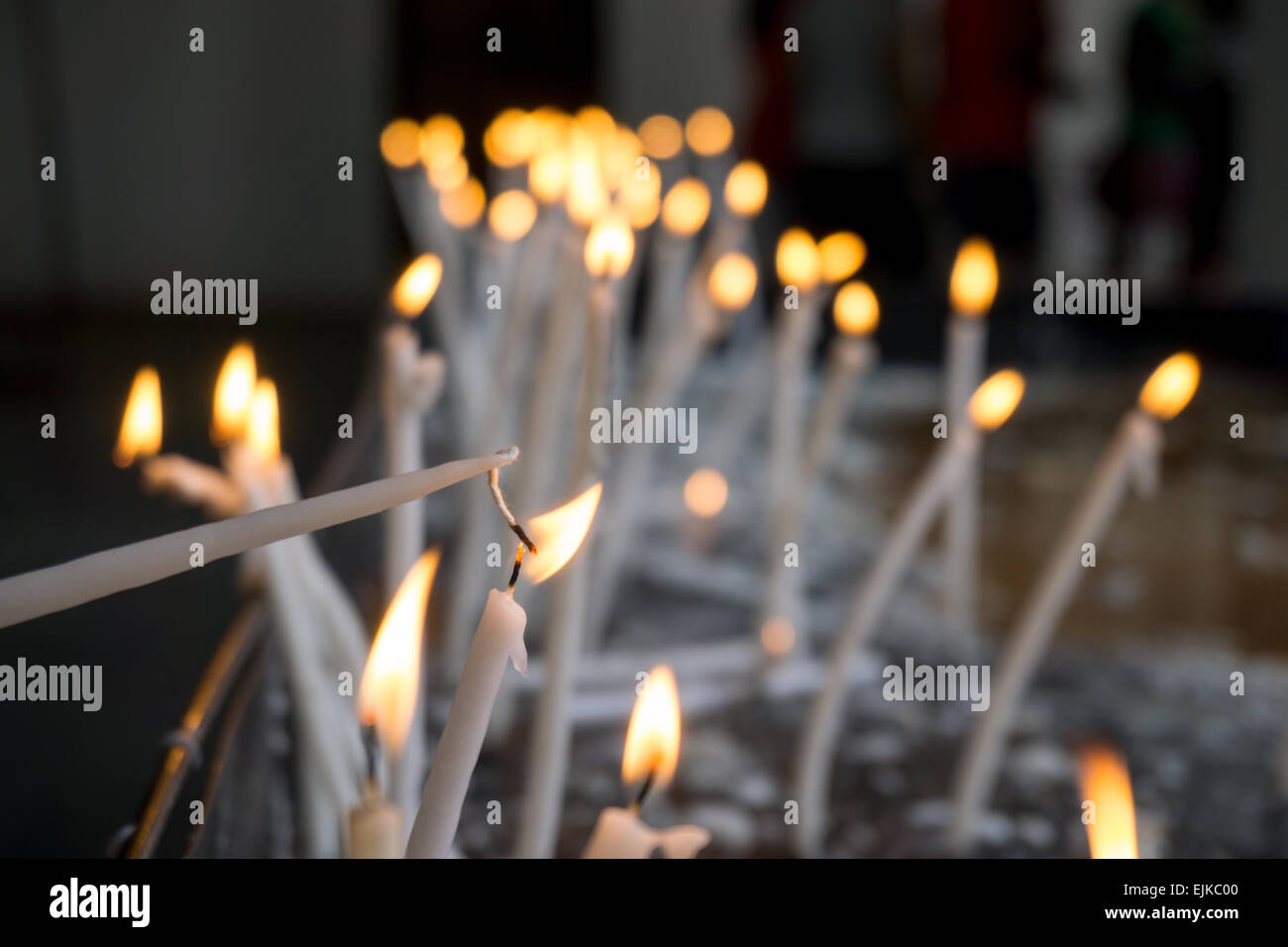 Prayers lighting candles in church Stock Photo Alamy