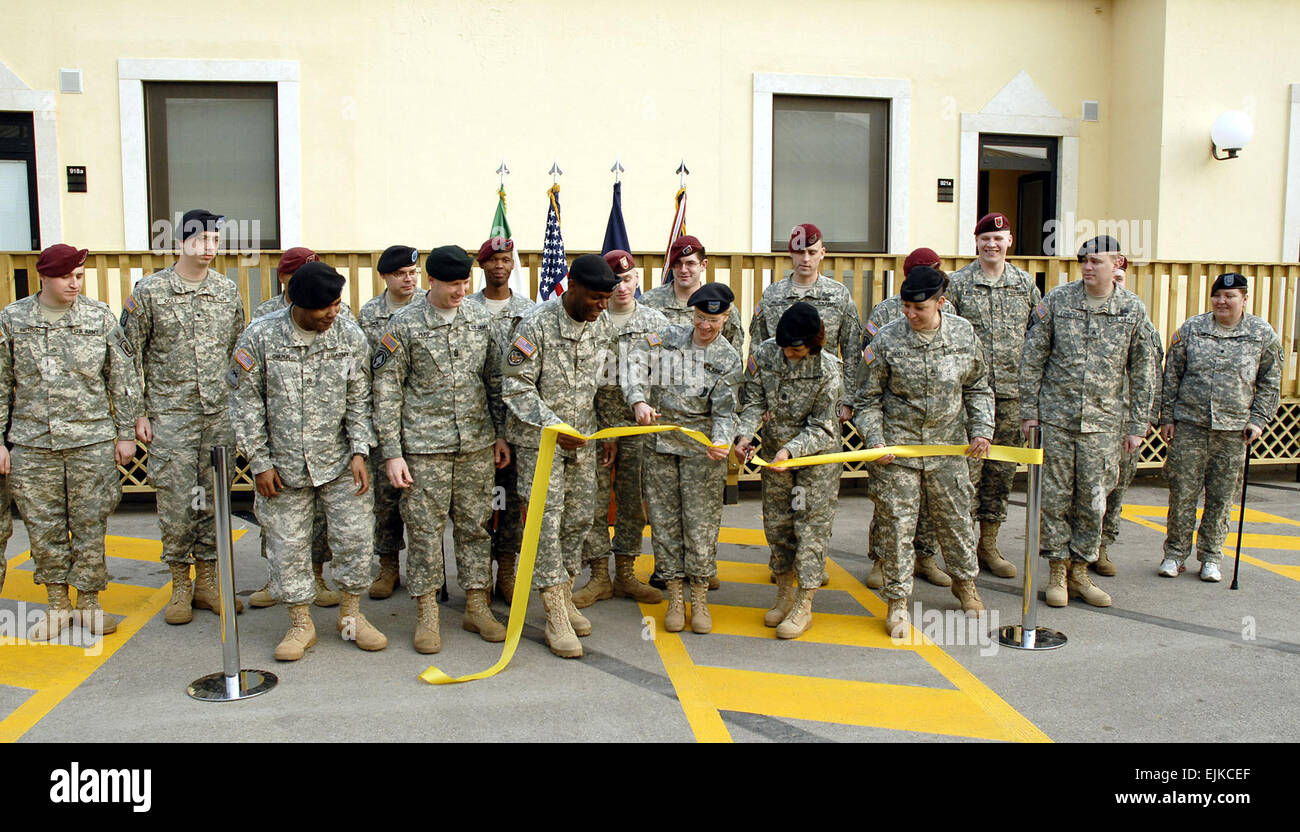 From center left, U.S. Army Command Sgt. Maj.  Phillips, command sergeant major of U.S. Army Garrison-Vicenza USAG-V; Col. Williams, commander of USAG-V; Col. Breen, U.S. Army Health Clinic in Vicenza commander; and Command Sgt. Maj. Rivera, U.S. Army Health Clinic in Vicenza command sergeant major, cut the ribbon at the Warrior Transition Unit single soldier quarters ribbon-cutting ceremony while some wounded Warriors look on in Vicenza, Italy, Feb. 22, 2008.  Barbara Romano Stock Photo