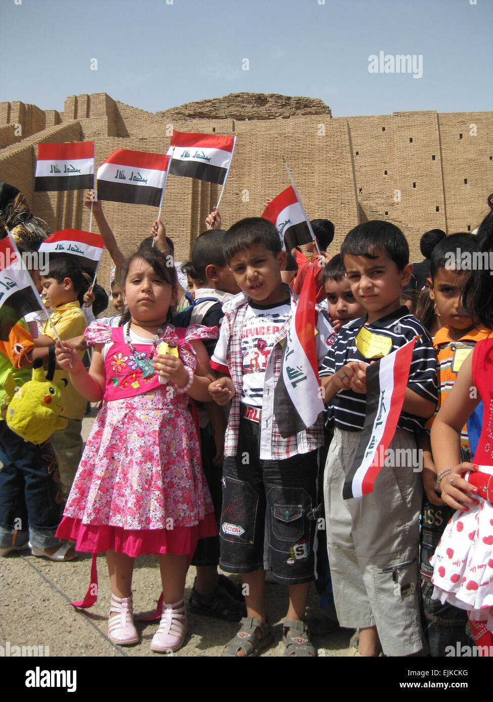 Kindergarten students from Mumsuna school in Nasiriyah, Iraq, attend a ceremony marking the transfer of the Ziggurat of Ur from U.S. to Iraqi control. The Ziggurat had been closed to the public since 2003. The Ziggurat was constructed in 2100 B.C. by Sumerian King Ur-Nammu. The ceremony was attended by Iraqi government leaders and military representatives from Multi-National Division - South.   Maj. Myles Caggins Stock Photo