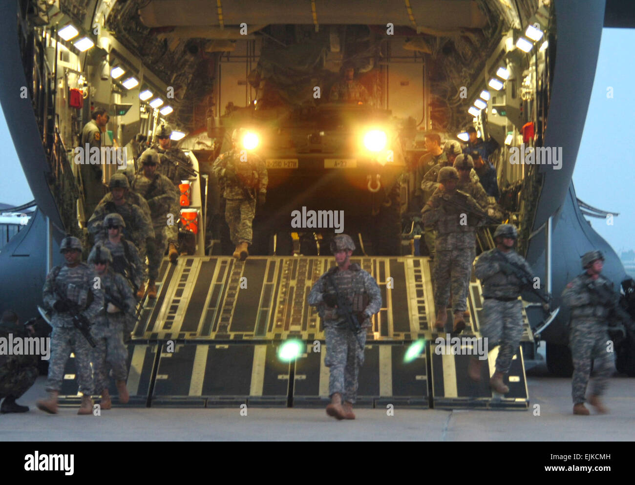 U.S. Army Soldiers from the 2nd Platoon, Alpha Company, 1st Battalion, 27th Infantry Division assume a security perimeter as an M1126 Stryker Infantry Carrier Vehicle exits a C-17 Globemaster aircraft March 18, 2007, at Daegu Air Base, South Korea, during Reception, Staging, Onward-Movement, and Integration/Foal Eagle 2007. The exercise is to demonstrate resolve to support the Republic of Korea ROK against external aggression while improving ROK/U.S. combat readiness and joint/combined interoperability. The focus of the exercise is on strategic, operational and tactical aspects of general mili Stock Photo