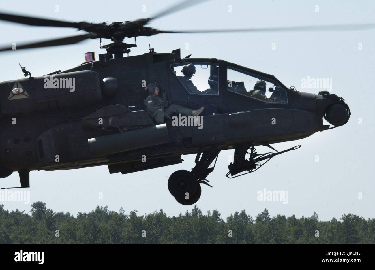 Chief warrant officer 3 Mark Grissom, a Blackhawk pilot with TF Eagle, rides shotgun on an AH-64 Apache during an Apache extraction exercise Aug. 25 at Camp Bondsteel, Kosovo. Stock Photo