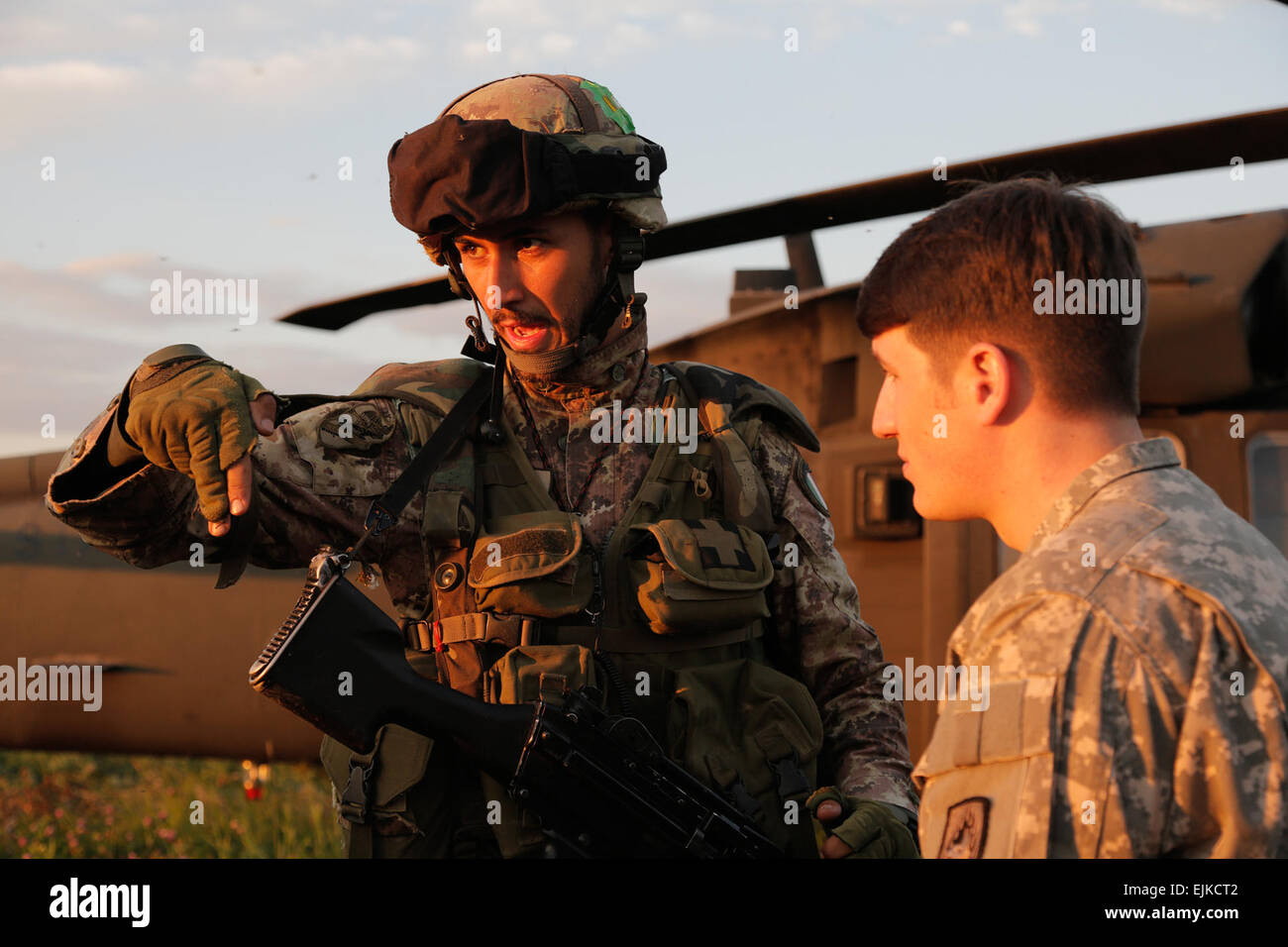 An Italian paratrooper from the Folgore Parachute Brigade reviews proper exit procedures of UH-60 Black Hawk with a U.S. Soldier from 12th Combat Aviation Brigade during rehearsals for an air assault on Lielvarde Airbase, Latvia, during NATO exercise Steadfast Javelin II. Steadfast Javelin II is a NATO exercise involving over 2,000 troops from 10 nations and takes place across Estonia, Germany, Latvia, Lithuania and Poland. The exercise focuses on increasing interoperability and synchronizing complex operations between allied air and ground forces through airborne and air assault missions. U.S Stock Photo