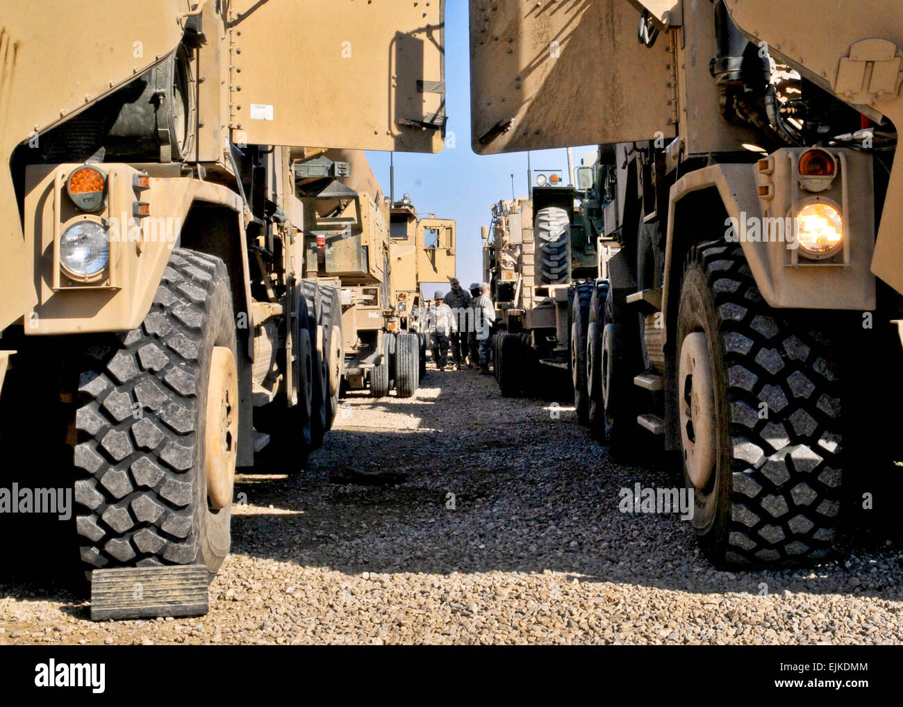 Soldiers with the 68th Transportation Company perform maintenance checks on heavy equipment transportation trucks at a motor pool on Contingency Operating Base Adder, Nov. 30. The unit loaded the trucks up with military equipment bound for Kuwait to support the drawdown of U.S. Forces in Iraq. Stock Photo