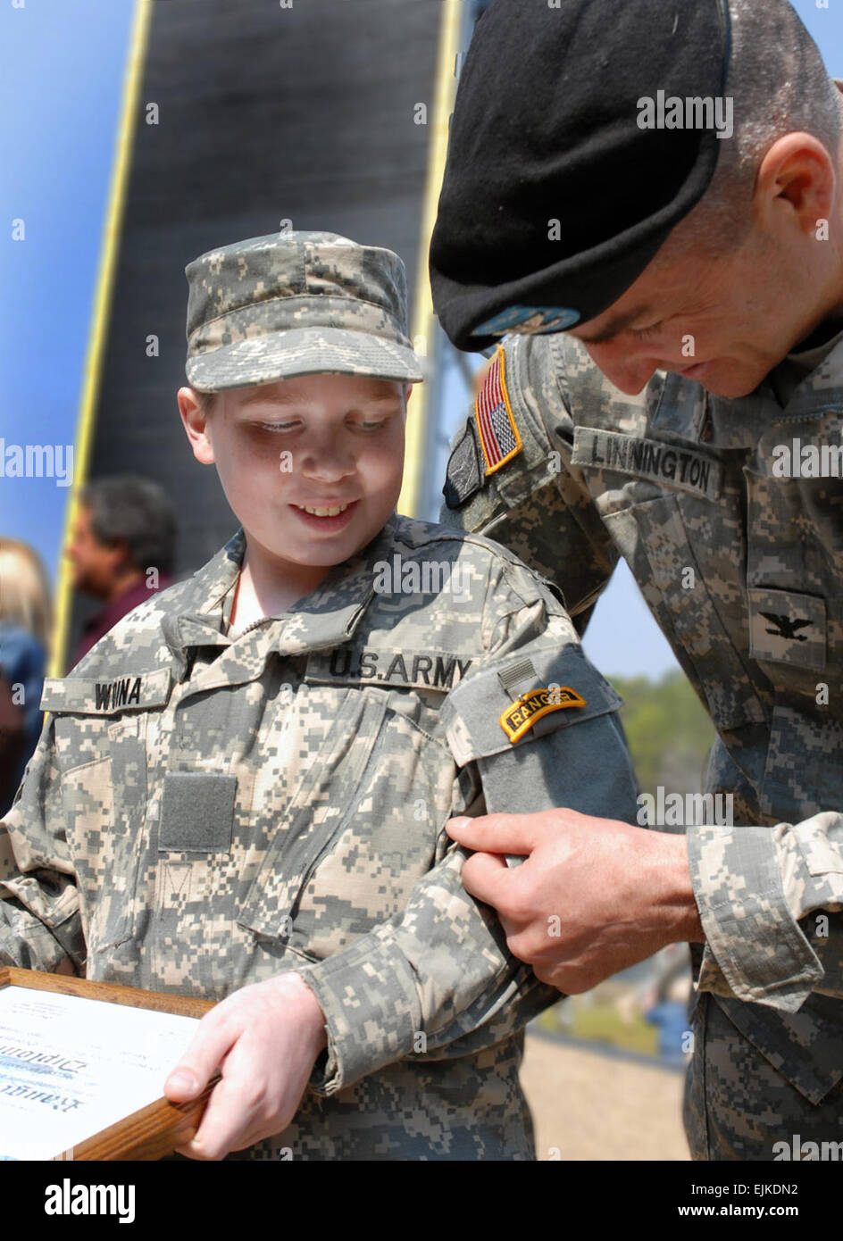 14-year old Riley Woina, of Plymouth, Conn., left became one of the Army’s newest Rangers during a graduation at Fort Benning today.  Col. Michael Linnington, United States Army Infantry School's Assistant Commandant pinned him with a coveted Ranger tab.  Woina, who has been diagnosed with cycstic fibrosis, stood in the ranks with other Ranger students at Fort Benning with the help of Fort Benning’s Ranger Training Brigade and the Make-A-Wish Foundation.  As part of his wish, Woina spent a week training with the Ranger students at Camp Rudder, during the &quot;swamp phase.”  Swamp phase is the Stock Photo