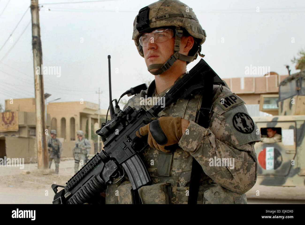 U.S. Army Sgt. Justin Haugen provides security for a new market in Abu Ghraib, Iraq, April 29, 2009. Haugen is assigned to 8th Military Police Brigade.  Staff Sgt. Mark Burrell Stock Photo