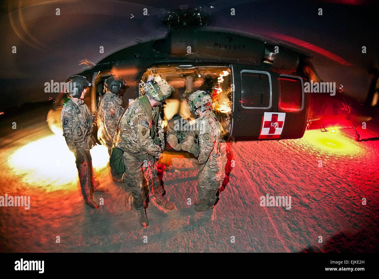 Army medics unload a mock casualty from a UH-60 Black Hawk medevac helicopter during a training exercise at the Joint Readiness Training Center on Fort Polk, La., Jan. 23, 2012. Sgt. Michael J. MacLeod Stock Photo