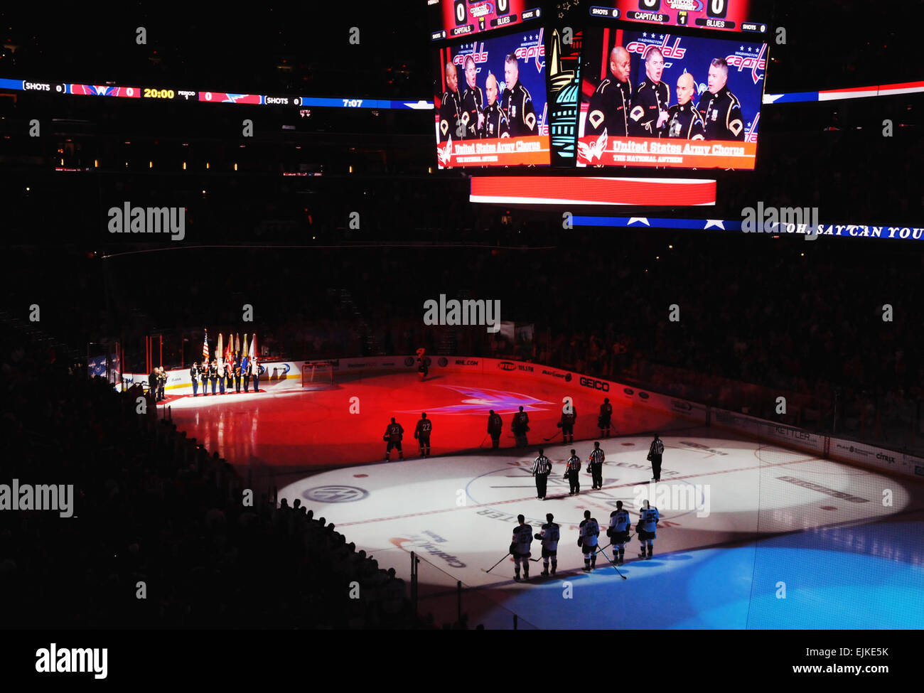 The Joint Armed Forces Color Guard renders honors as the U.S. Army Chorus sings the national anthem before the the start of the Washington Capitals hockey team's 8th Annual Military Appreciation Night, at the Verizon Center in Washington, D.C., March 3, 2011. DOD photo by U.S. Navy Petty Officer 2nd Class William Selby Stock Photo