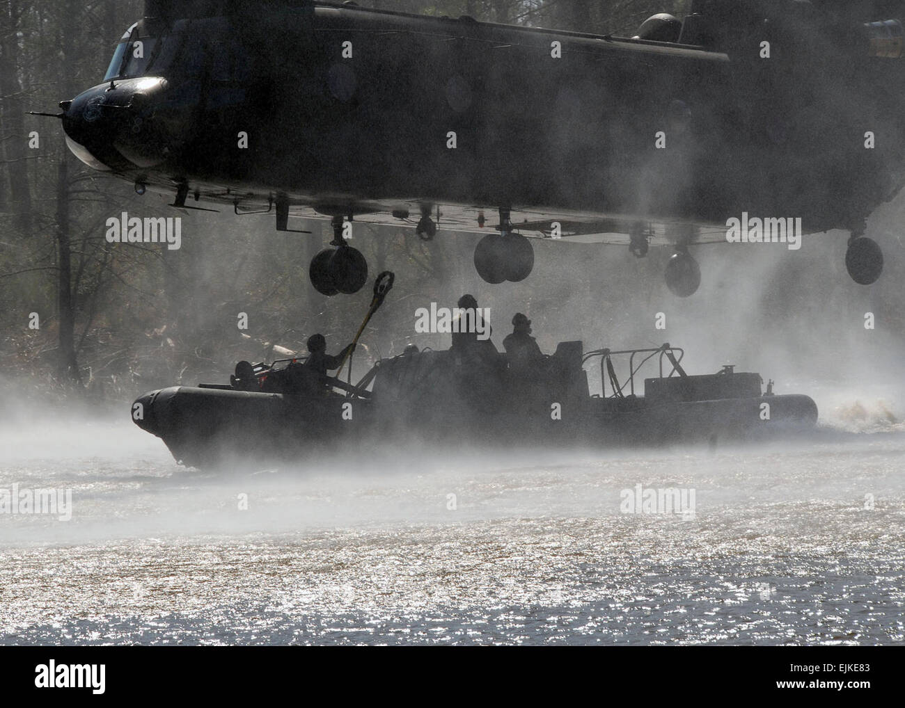 An Army CH-47D Chinook helicopter assigned to the 159th Aviation Regiment out of Fort Eustis, Va., hovers over an 11-meter rigid-hull inflatable boat RHIB during a maritime external air transportation system along the Pearl River in Mississippi Feb. 14, 2008. Special warfare combatant-craft crewmembers aboard the RHIB secured the boat to the helicopter with specter slings and used a caving ladder to board. CH-47D Chinook helicopters can transport RHIB's over land or water.  Mass Communication Specialist 3rd Class Robyn Gerstenslager Stock Photo