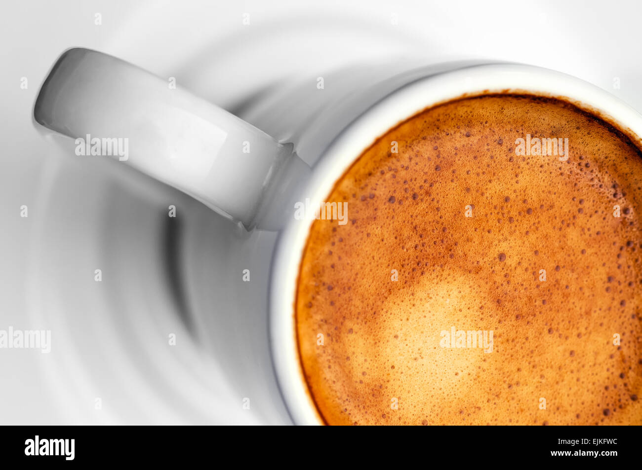 Macro close up studio shot of a half cup of espresso coffee - diagonal Stock Photo