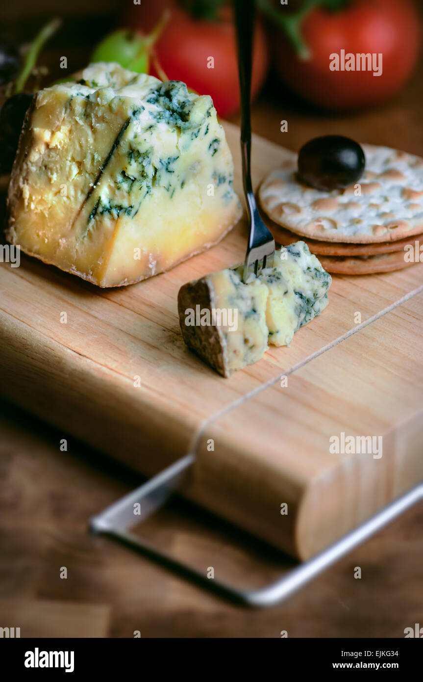 Cheese board Stilton mature blue mouldy and grapes and crackers Stock Photo