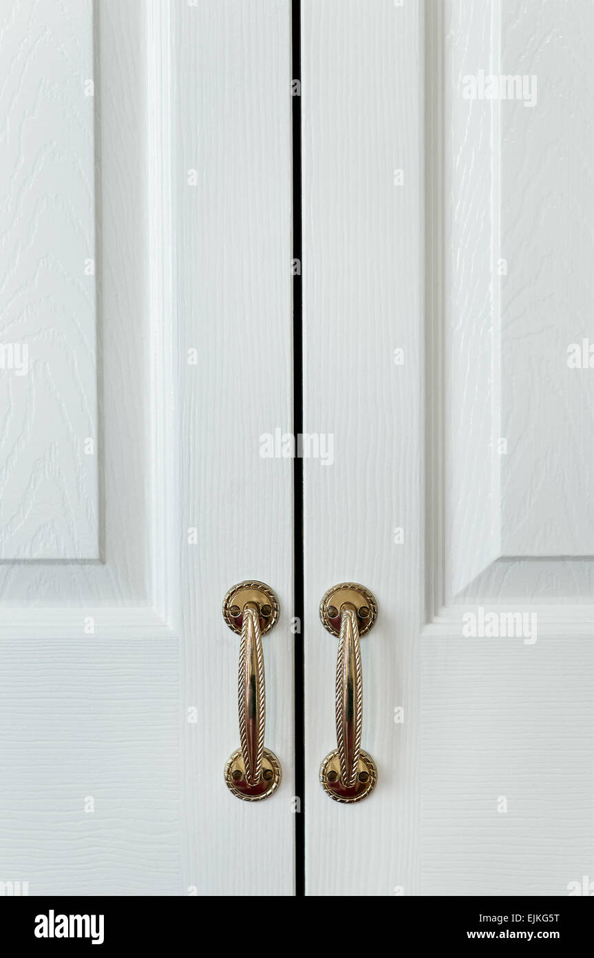 Closet wardrobe cupboard painted white with vintage handles hotel room Stock Photo