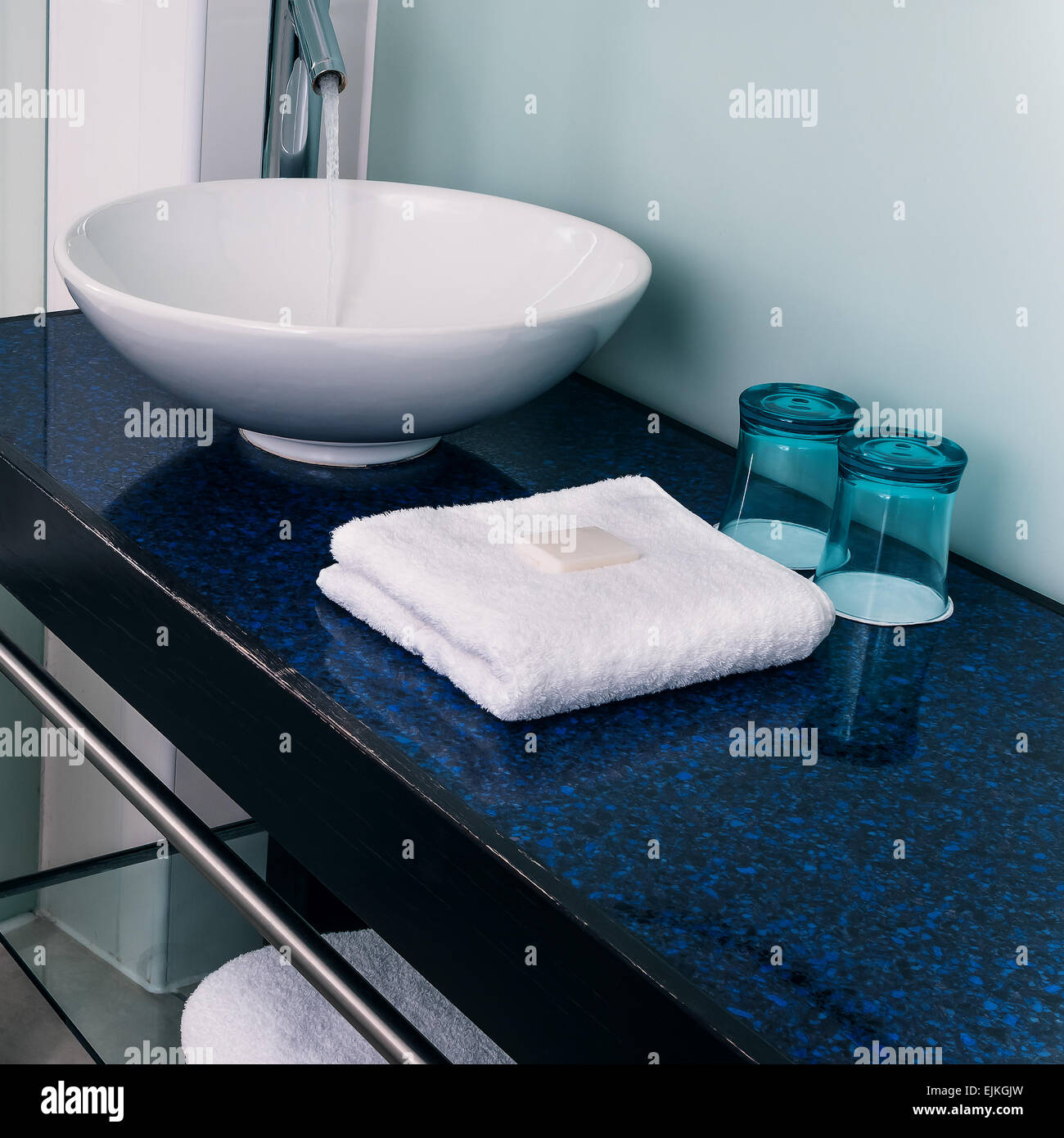 Bathroom sink counter towels water glass blue Stock Photo