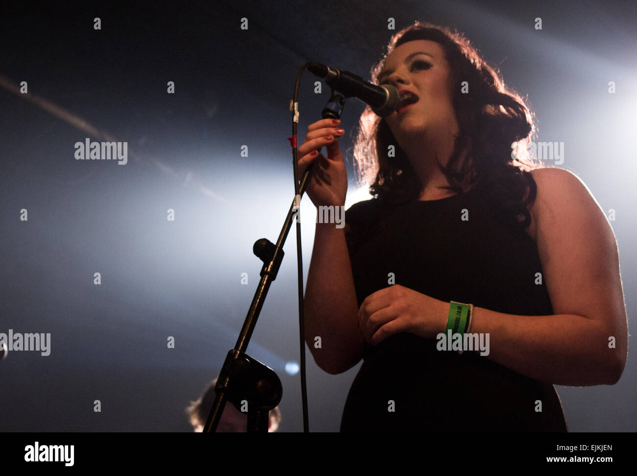 British female vocalist singing in a band at a venue in Hampshire, UK. Stock Photo