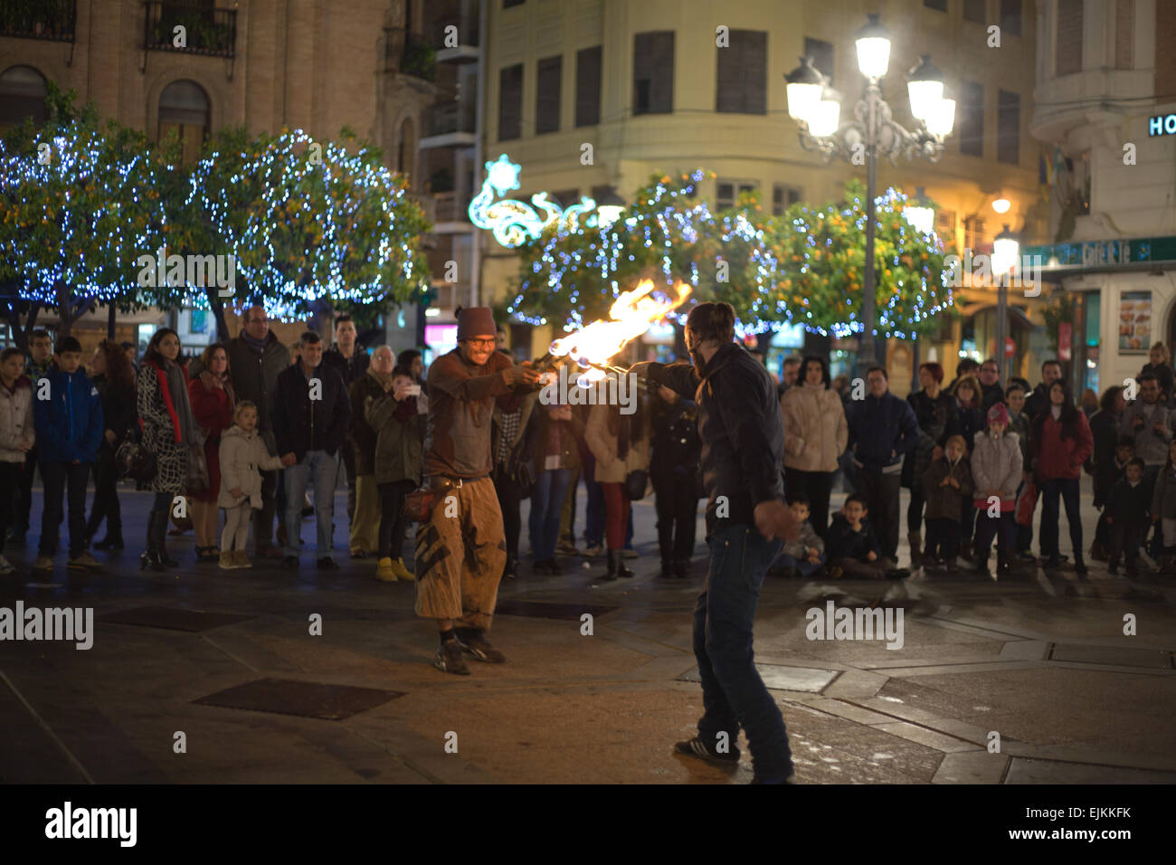 CORDOBA - JAN 4: A street entertainer playing with fire torch in front of a large crowd of people, on January 4, 2015 in Cordoba Stock Photo