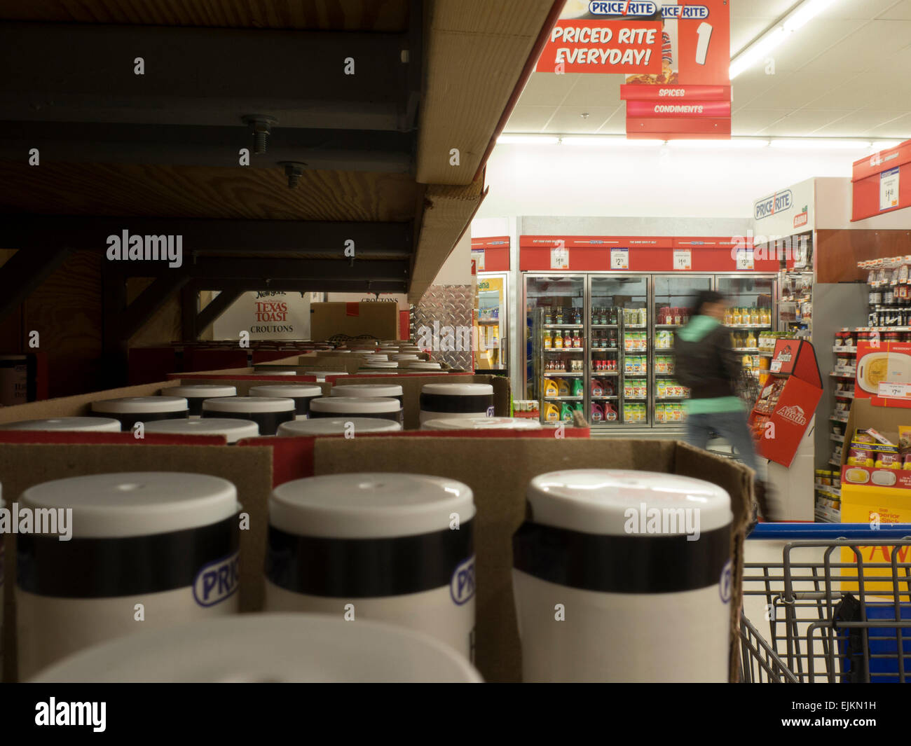 View of supermarket isle from below a grocery shelf in a warehouse
