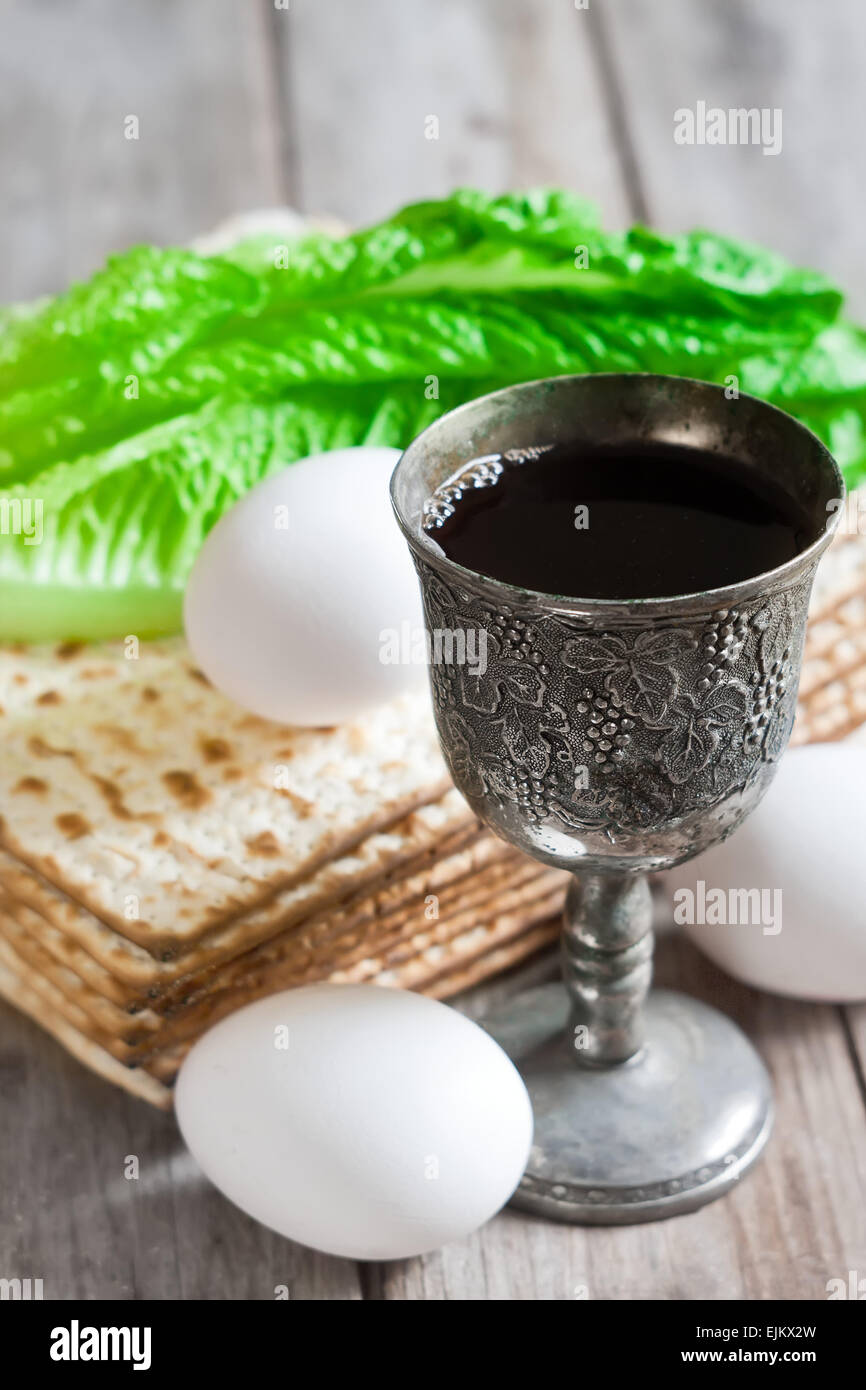 Wine, egg, bitter salad leaves, matzot - traditional jewish passover celebration elements. Stock Photo