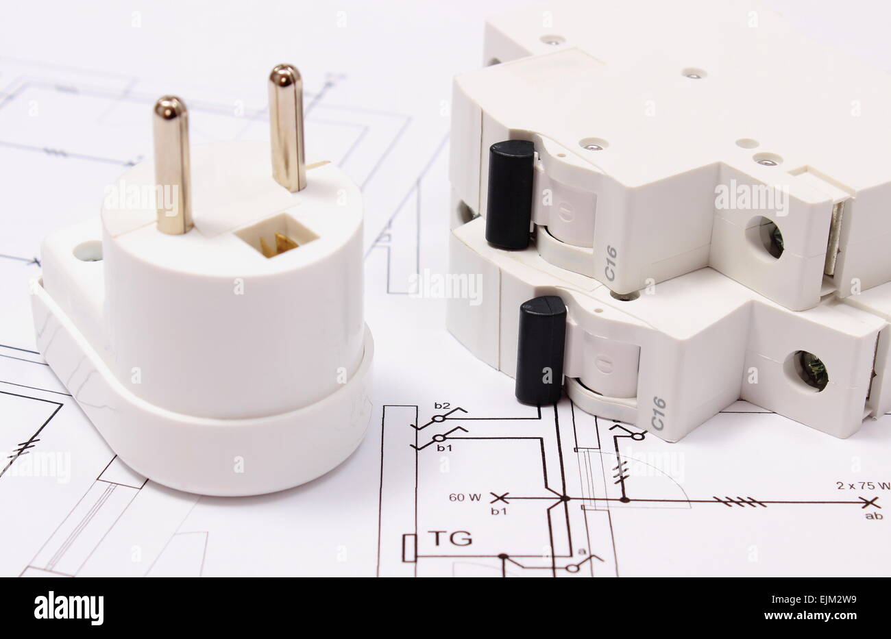 Electric plug and fuse lying on construction drawing of house