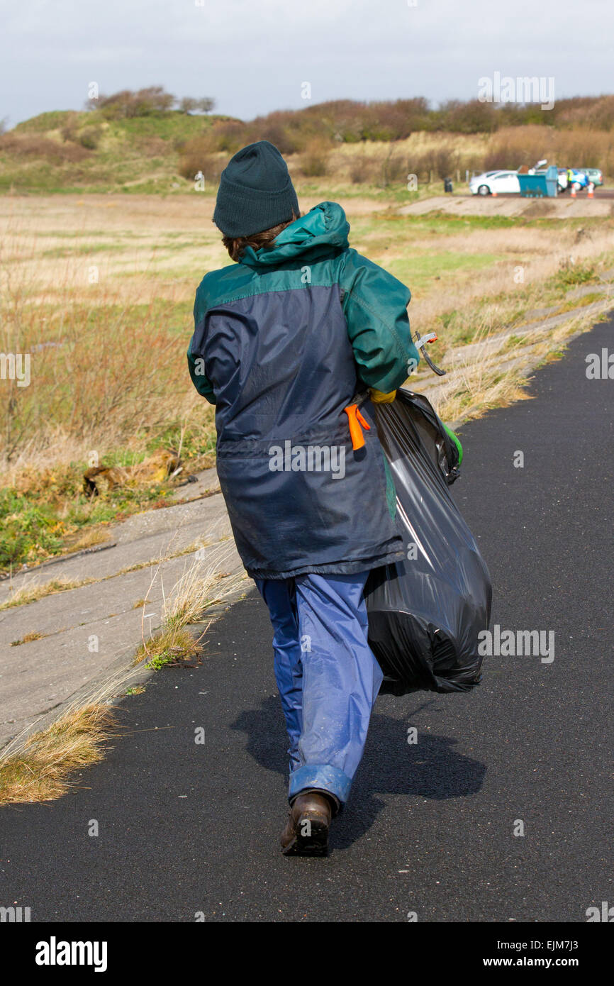 Southport, Sefton, Merseyside, UK. 29th March, 2015. UK Weather.   RSPB Beach 'Pick Up' of sea-borne trash, rubbish & marine debris after overnight gales. Litter and plastic waste washed up on the littered marshes of Ribble Marshside Nature Reserve from the Irish Sea being collected by Marine conservation volunteers. This debris can be collected by wildlife that use it in their nests and are subsequently killed by strangulation or by swallowing smaller particles of the harmful waste plastics. Stock Photo