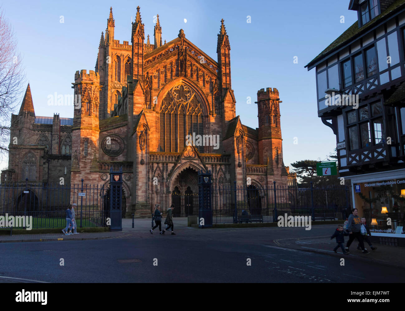 Hereford Cathedral west front its towers reaching into the sky catching the days last rays of sun. Stock Photo
